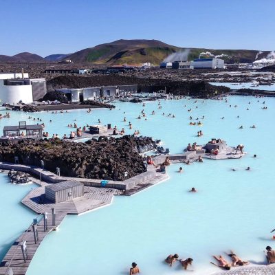 View Of People Bathing In The Blue Lagoon During A Private Luxury Transfer From Keflavik Airport To Reykjavik