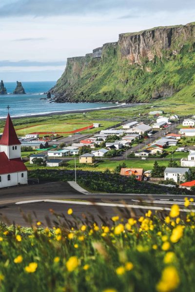 View Of Vík With The Wooden Church And The Sea Stack